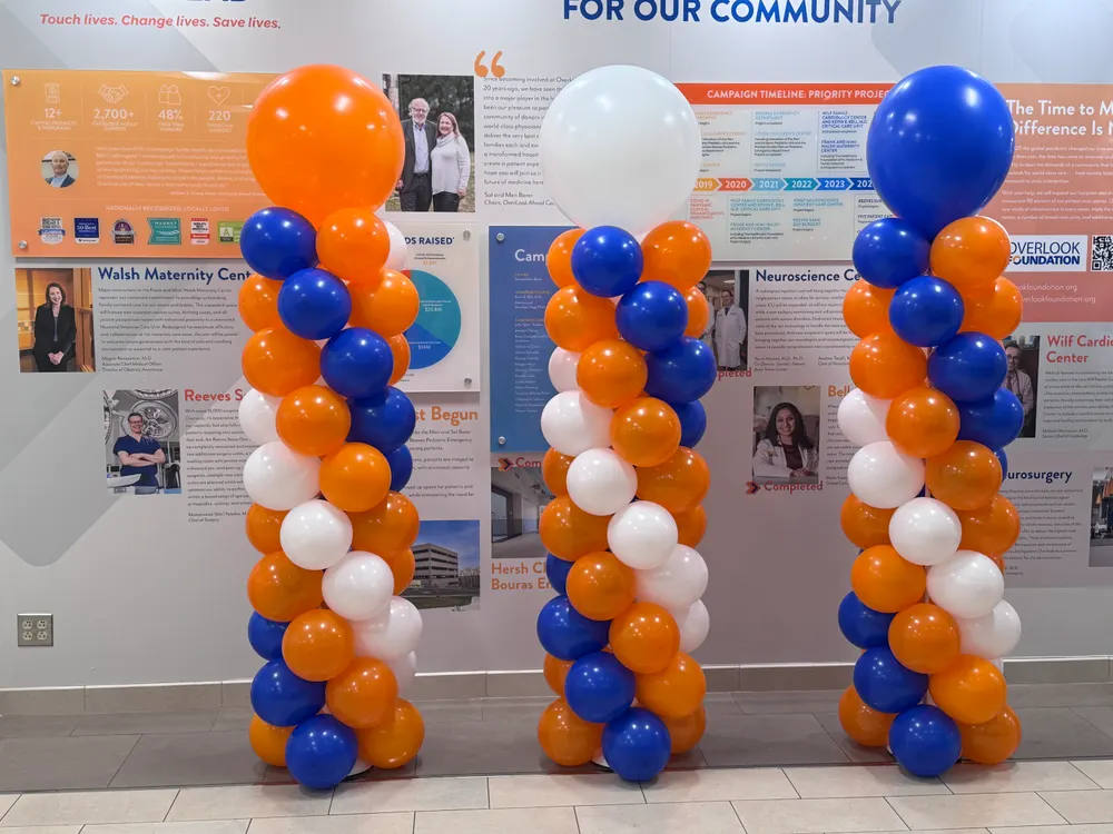 Orange and blue balloon columns for a corporate event