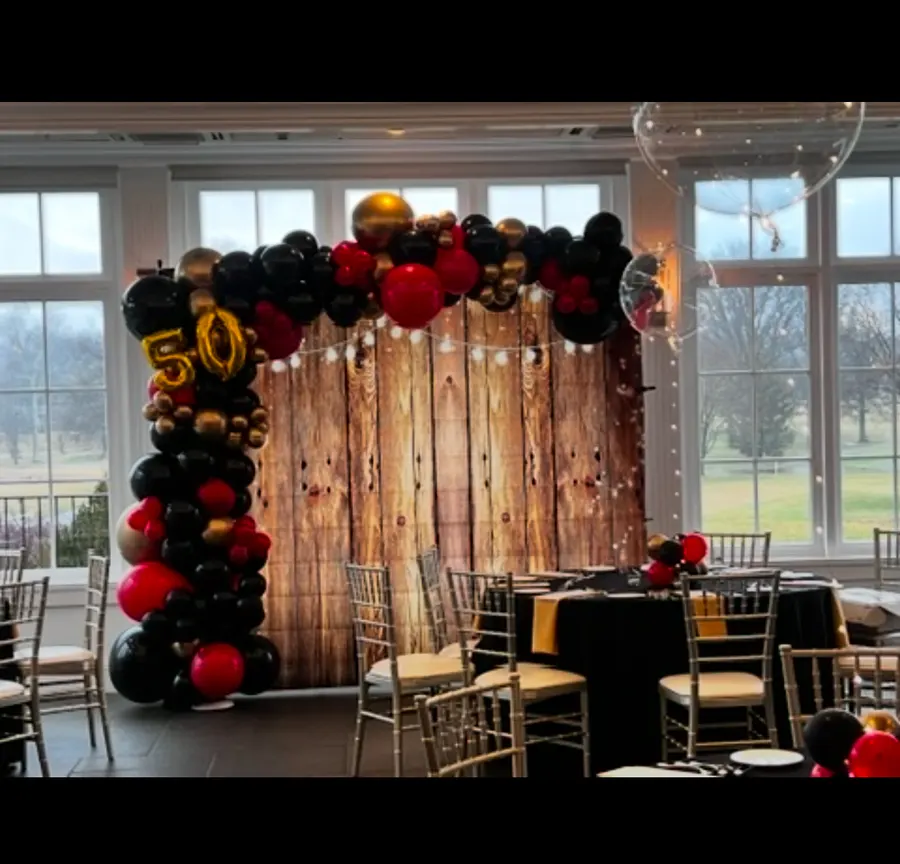 50th birthday balloon garland on a rustic wood backdrop