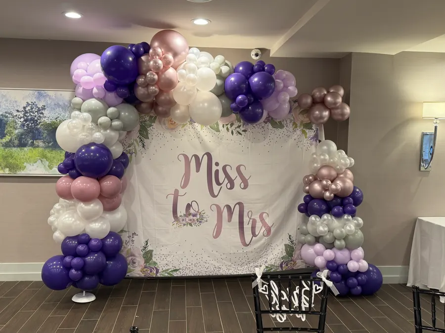 Miss to Mrs bridal shower balloon arch in purple, white and rose gold
