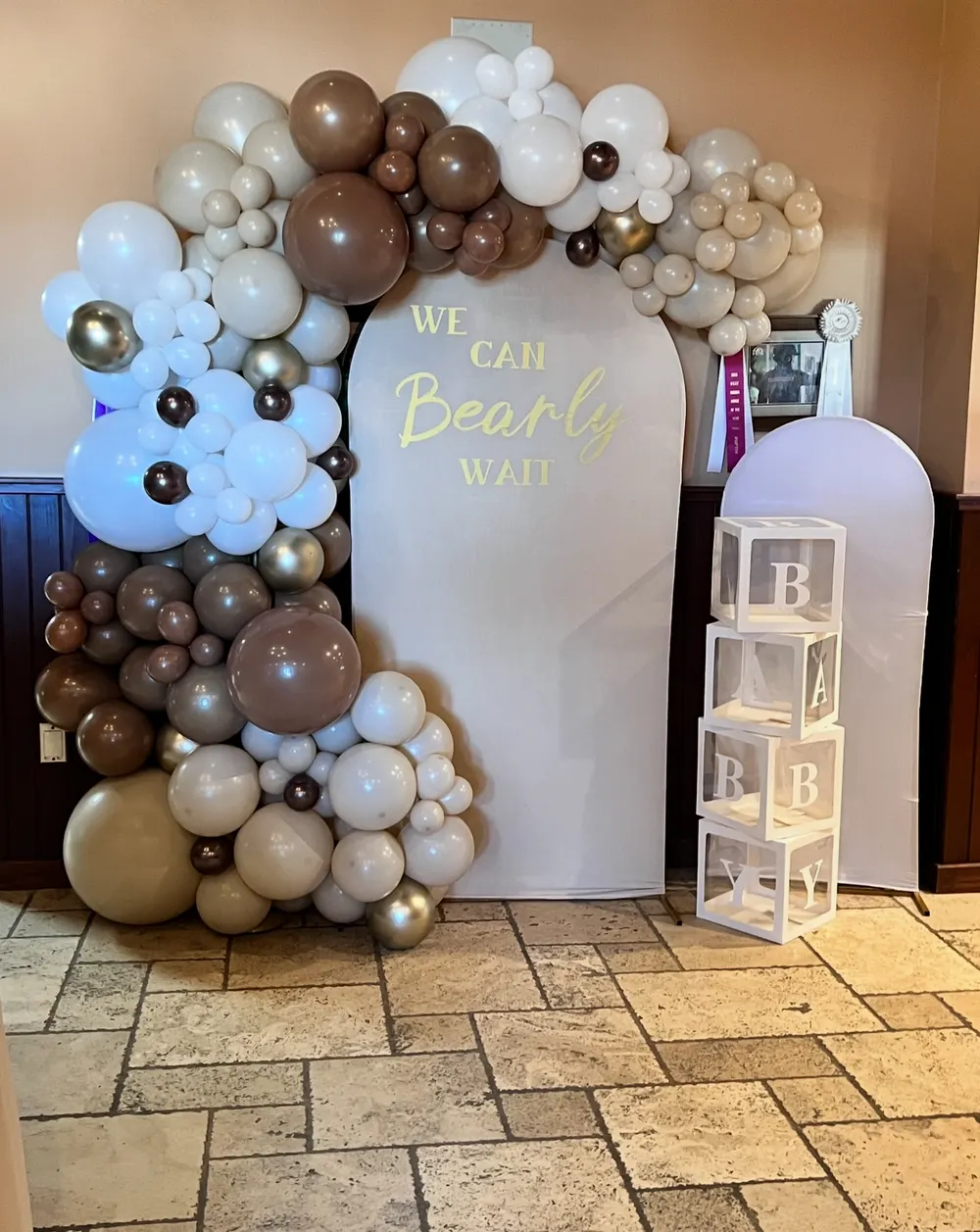 Neutral organic balloon arch with baby shower letter blocks