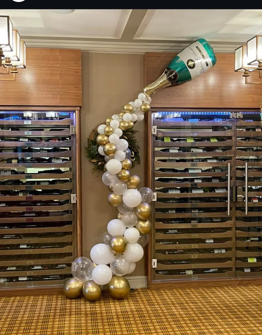 Balloon champagne bottle pouring a cascade of balloons